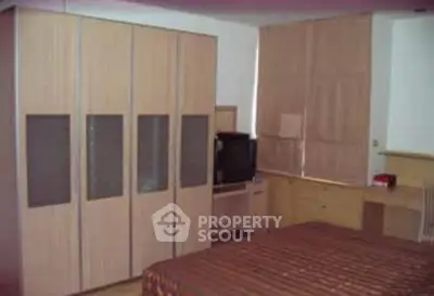 Cozy bedroom with large wardrobe and modern decor