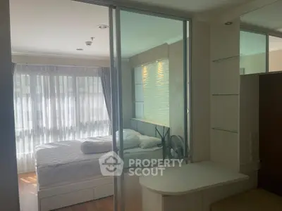 Modern bedroom with glass partition and natural light