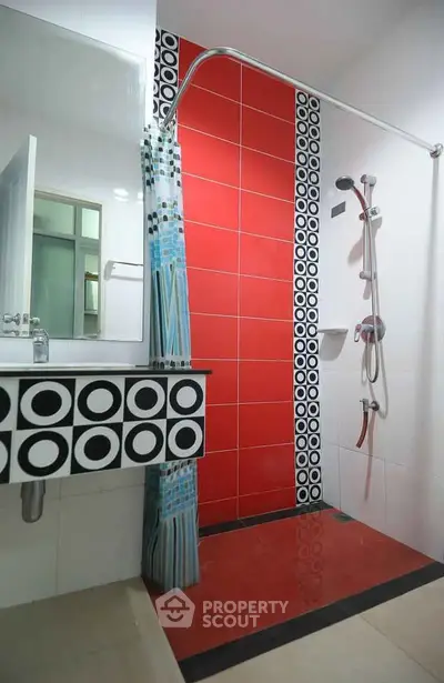 Modern bathroom with vibrant red tiles and stylish shower design