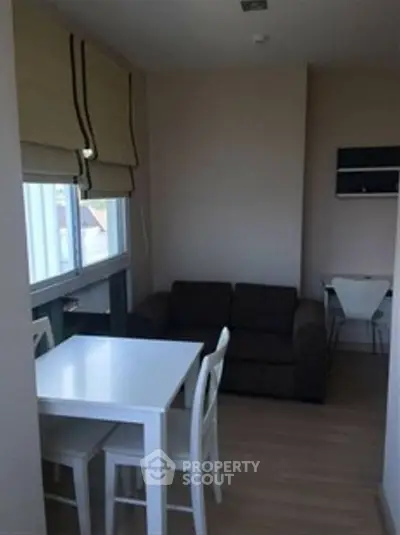 Cozy small living room with dining area and natural light