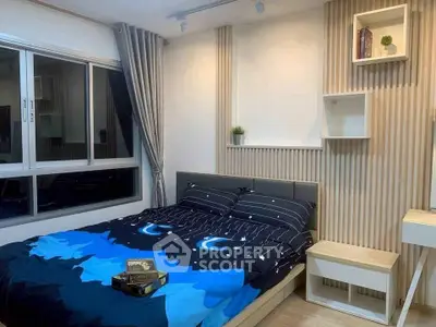 Cozy bedroom with modern decor and large window, perfect for relaxation and comfort.