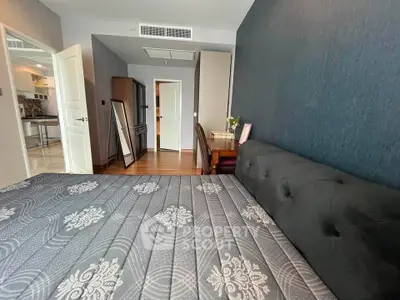 Spacious bedroom with elegant decor and stylish furniture in modern apartment.