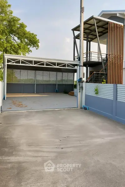Modern home exterior with spacious driveway and sleek architectural design.