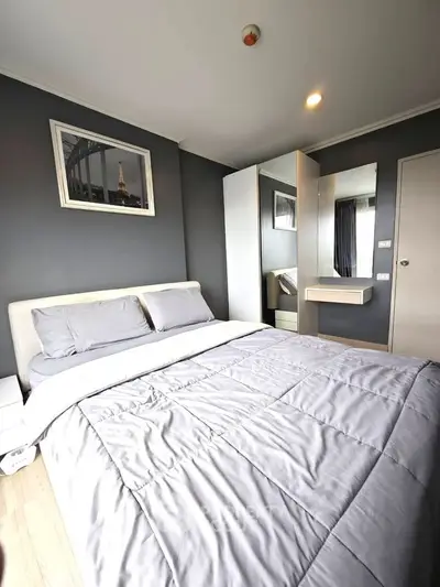 Modern bedroom with sleek design and cozy ambiance, featuring a stylish bed and contemporary decor.
