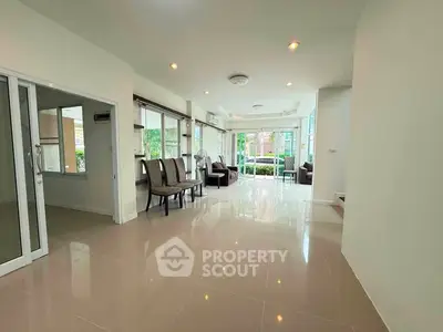 Spacious living room with modern design and large windows offering natural light.