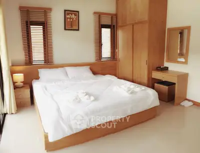 Cozy bedroom with modern wooden furniture and soft lighting, perfect for relaxation.
