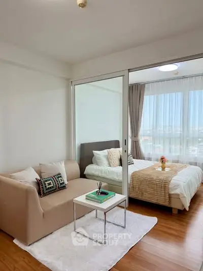 Cozy studio apartment with sliding glass doors and wooden flooring