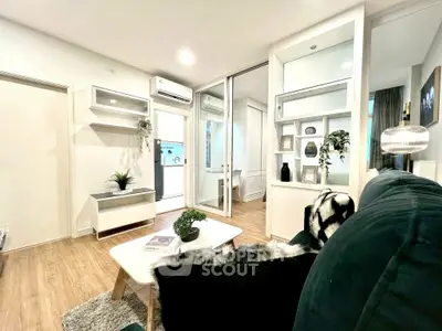 Modern living room with stylish decor and open layout, featuring cozy seating and elegant furnishings.