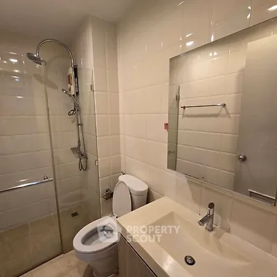 Modern bathroom with glass shower and sleek fixtures