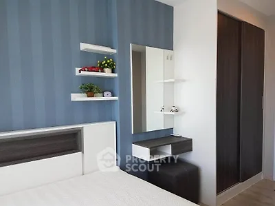 Modern bedroom with sleek design, featuring built-in wardrobe and stylish decor.