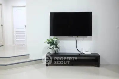 Modern living room with sleek TV setup and minimalist decor
