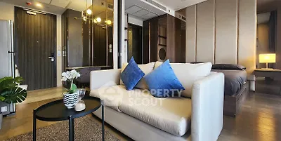 Modern living room with stylish decor and cozy seating in an open-concept apartment.
