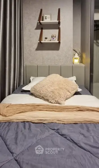 Cozy bedroom with stylish decor and plush bedding