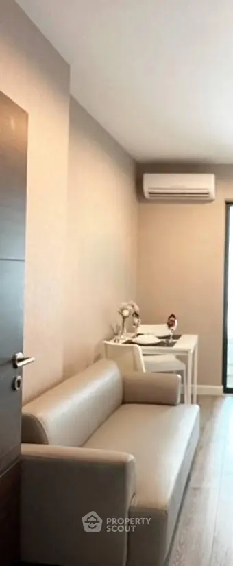 Modern living room with sleek sofa and air conditioning, perfect for cozy relaxation.