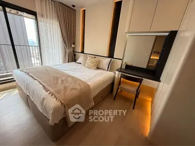 Luxurious bedroom with modern decor and large window offering natural light.