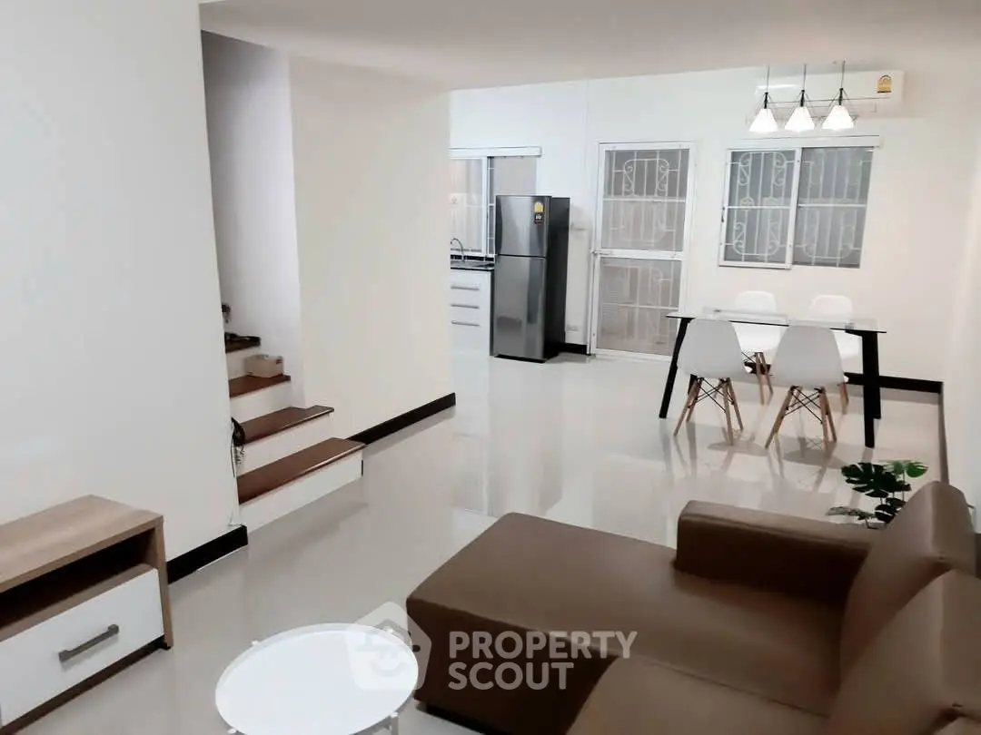 Modern open-plan living room with sleek kitchen and dining area