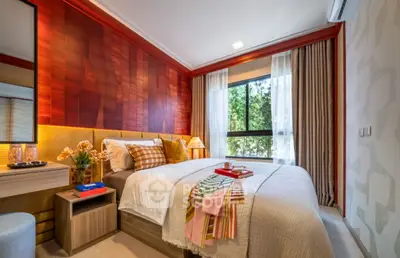 Luxurious bedroom with stylish decor and large window offering natural light