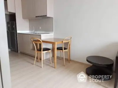 Modern kitchen with wooden dining set and sleek cabinetry