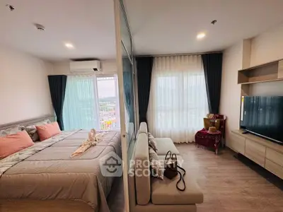 Modern bedroom with stylish decor and large windows offering natural light and scenic views.