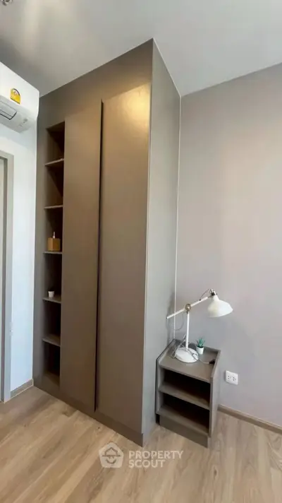 Modern bedroom with sleek wardrobe and stylish bedside lamp