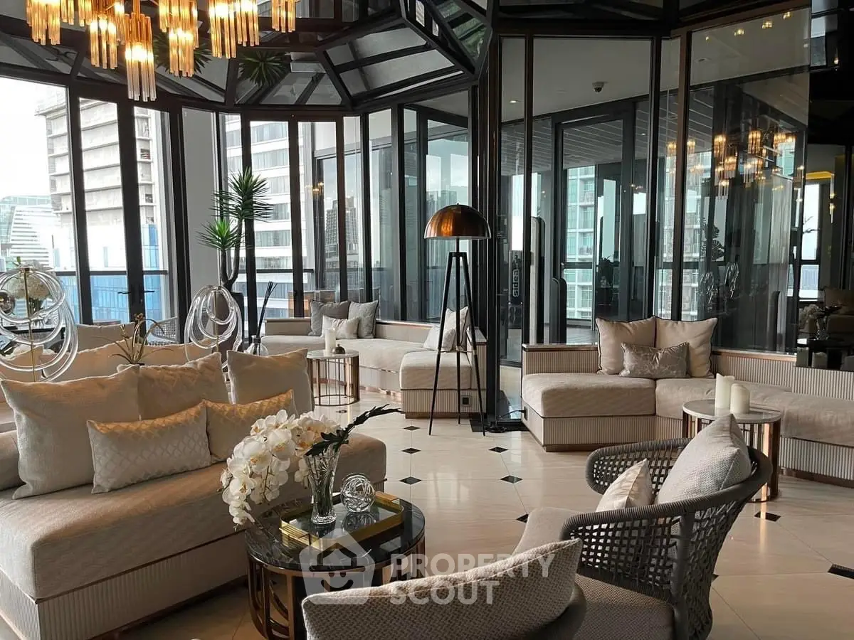 Luxurious living room with panoramic windows and elegant decor in a high-rise building.