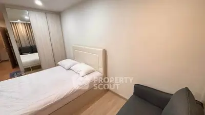 Cozy bedroom with modern furnishings and ample natural light, perfect for relaxation.