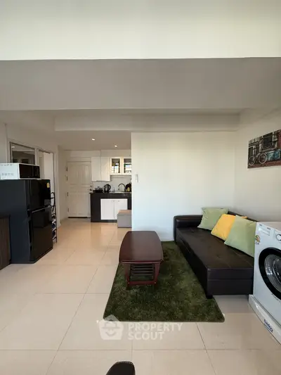 Spacious living room with modern furniture and open kitchen layout