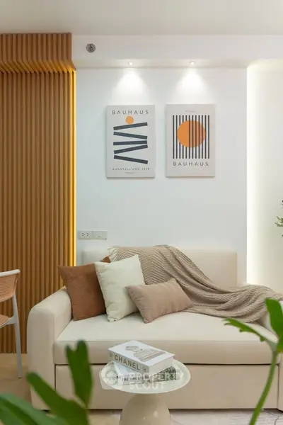 Modern living room with cozy sofa, stylish decor, and warm lighting