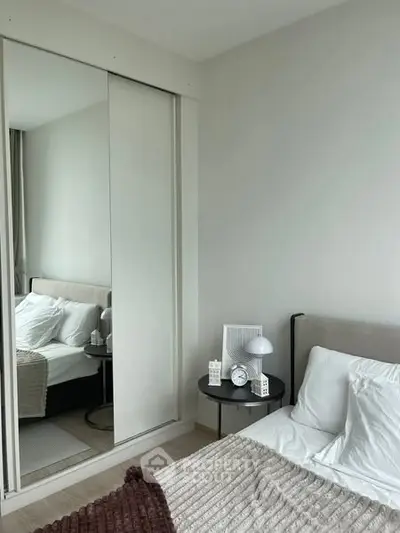 Modern bedroom with cozy decor and mirrored wardrobe