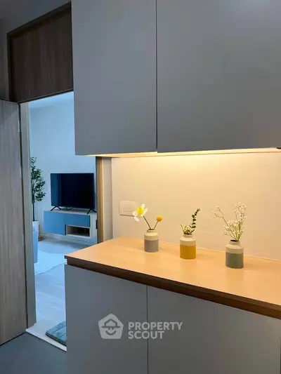 Modern interior with sleek cabinetry and cozy living room view, perfect for stylish urban living.