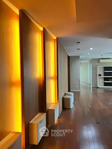 Spacious modern living room with elegant wooden flooring and ambient lighting