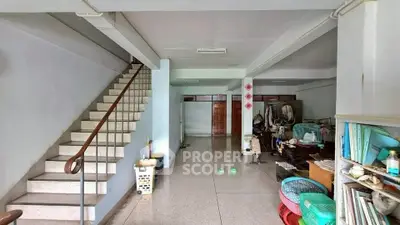 Spacious interior with staircase and open layout, ideal for creative renovation.