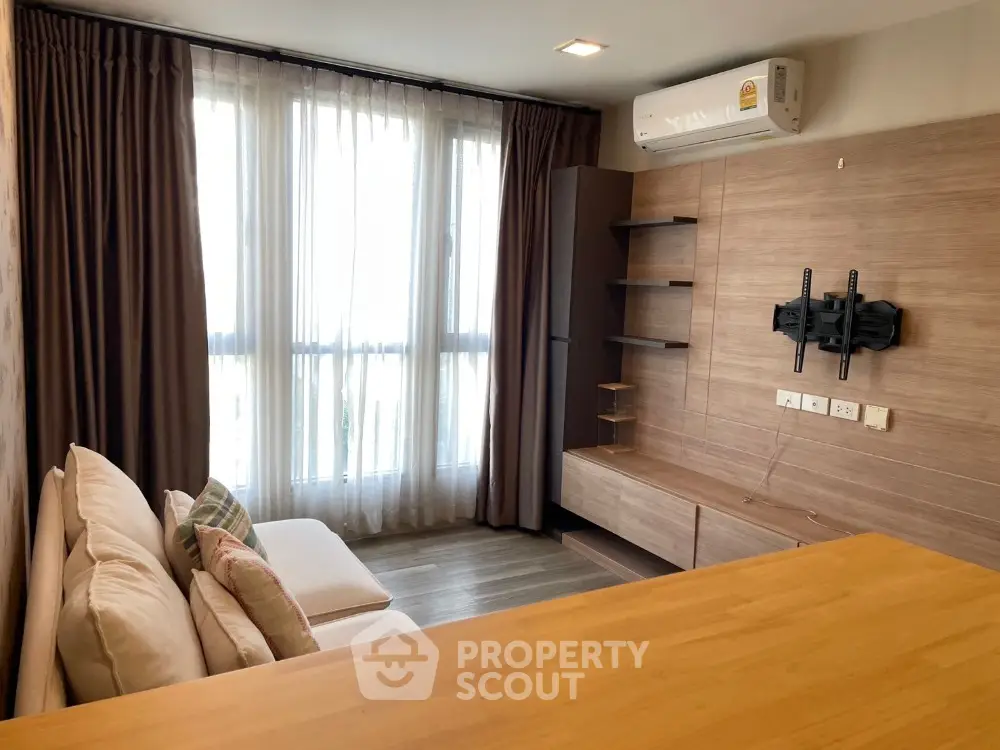 Modern living room with wall-mounted TV bracket and air conditioning