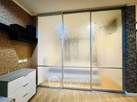 Modern bedroom with frosted glass sliding doors and stylish decor
