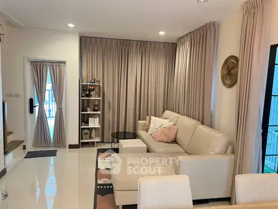 Stylish living room with elegant curtains and modern white sofa in a cozy apartment.