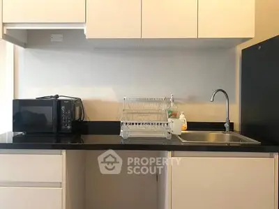 Modern kitchen with sleek cabinetry and countertop appliances