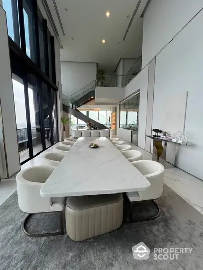 Luxurious modern dining area with high ceilings and panoramic windows in a sophisticated apartment.