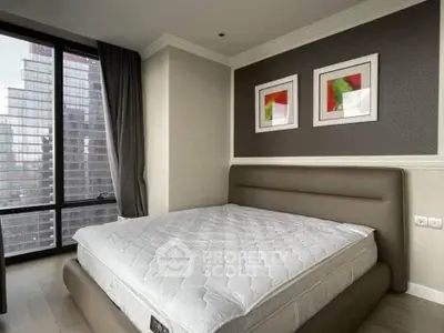 Modern bedroom with large window and stylish decor in urban apartment