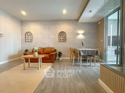 Spacious modern living room with stylish decor and dining area, perfect for entertaining guests.