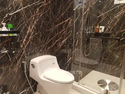 Luxurious marble bathroom with modern fixtures and glass shower enclosure