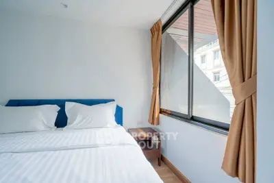 Bright bedroom with large window and modern decor