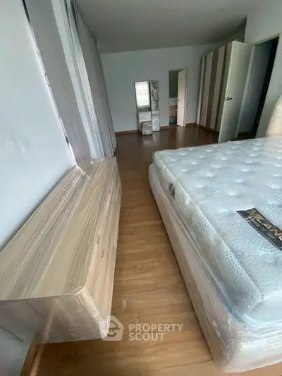 Spacious bedroom with new mattress and wooden flooring