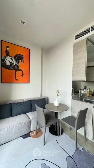 Modern living room with stylish decor and compact dining area