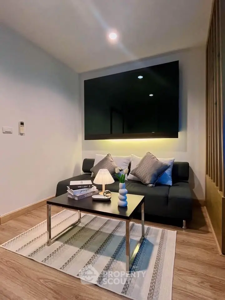 Modern living room with sleek sofa, stylish decor, and ambient lighting for a cozy atmosphere.