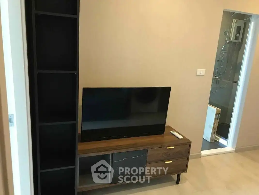 Modern living room with sleek TV stand and wall-mounted TV, perfect for cozy entertainment.