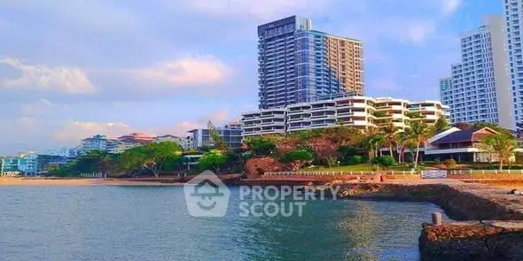 Stunning beachfront high-rise buildings with ocean view and lush greenery.