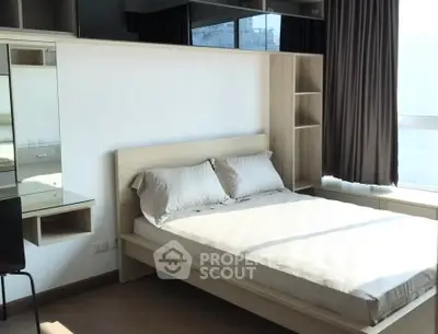 Modern bedroom with natural light and stylish furniture