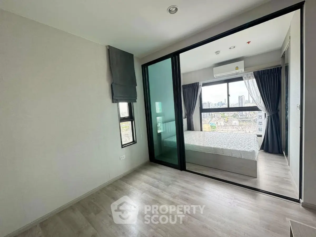 Modern apartment with glass partitioned bedroom and city view