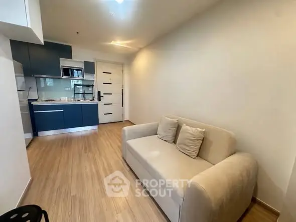 Modern apartment with cozy living room and sleek kitchen in open layout.