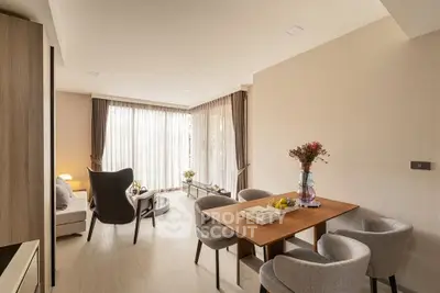 Elegant living room with modern furniture and large windows offering natural light.